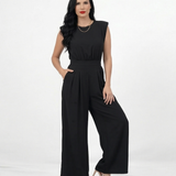 Enterizo negro con hombrera y manga corta estructurada, cintura elástica fruncida y pierna ancha con pinzas, perfecto para eventos y salidas nocturnas