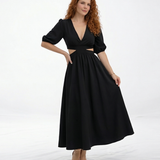 Vestido midi negro con escote en V cruzado, manga 3/4 abullonada y aberturas cut out en cintura, sofisticado para cócteles y salidas de noche