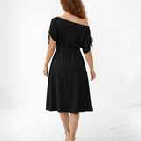 Vestido midi negro hombro asimétrico con manga corta y lazo en puño, cintura con lazo y falda midi con vuelo, sofisticado para eventos y salidas de noche