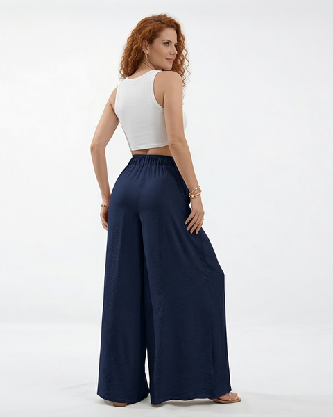 Pantalón palazzo azul marino super fluido con cintura elástica alta, cordón y pinzas frontales, fresco y elegante para fiestas, salidas y viajes en Colombia