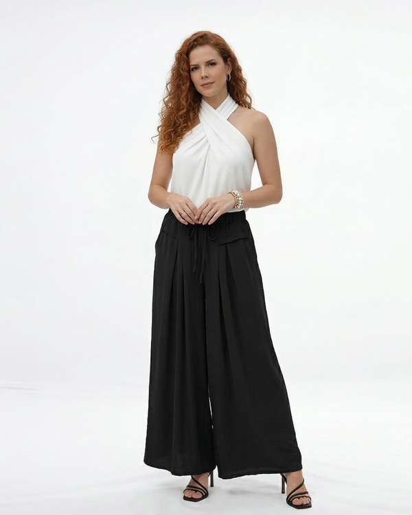 Pantalón palazzo negro super fluido con cintura elástica alta, cordón y pinzas frontales, versátil y sofisticado para fiestas, grados y matrimonios en Colombia
