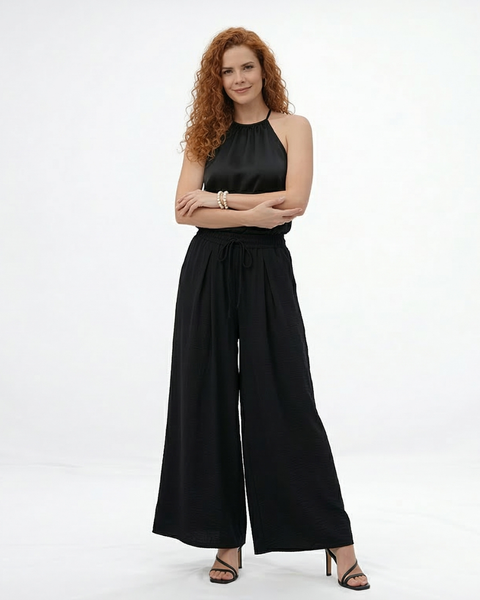 Pantalón palazzo negro super fluido con cintura elástica alta, cordón y pinzas frontales, versátil y sofisticado para fiestas, grados y matrimonios en Colombia