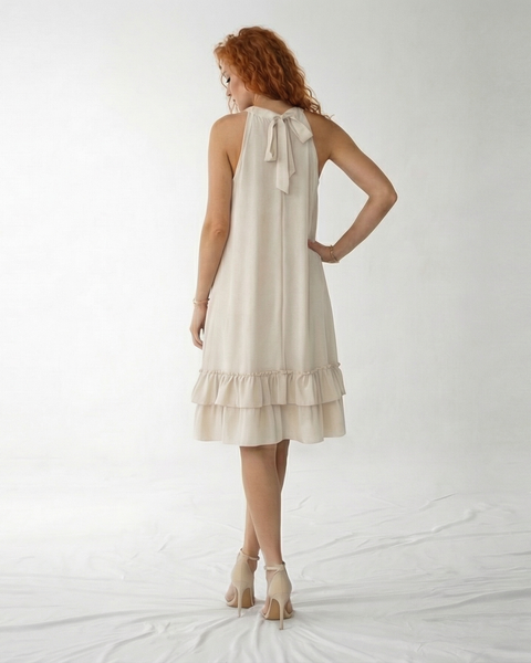 Vestido corto crema con cuello halter, abertura en escote, silueta suelta y doble volante en la falda, ideal para matrimonios de día, grados y eventos casuales