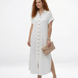 Vestido largo blanco tipo camisero con cuello de camisa, botones al frente, manga corta y abertura lateral, ideal para salidas casuales elegantes y días de calor